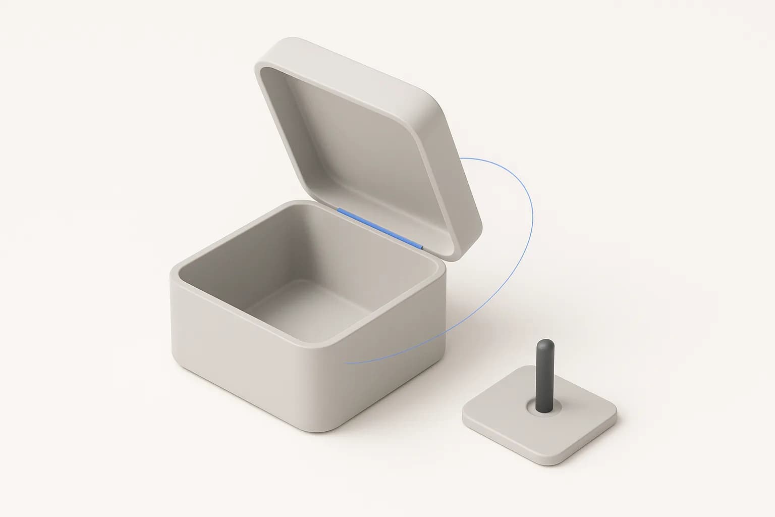 A matte grey box with its lid swung open on a blue hinge line along the back edge, a thin blue arc tracing the swing, and a charcoal pin standing in the bore of a small plate beside it